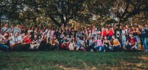 image showing 100 people posing for a company retreat picture